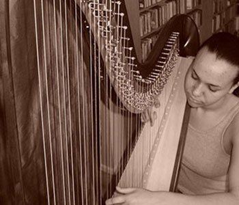 Photo of Aja playing harp