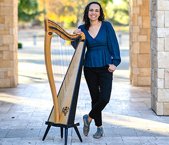 Photo of Aja with a harp