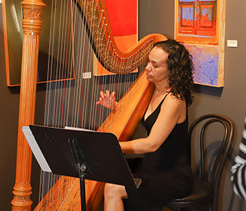 Photo of Aja playing harp